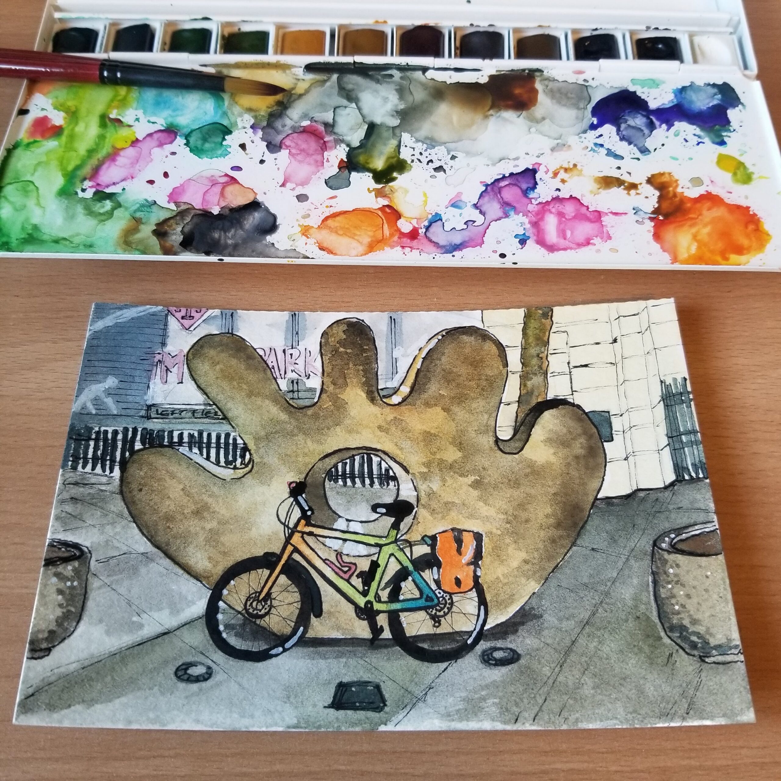 Watercolor postcard featuring a multi-colored commuter bike in front of Gerard Tsutakawa's sculpture, "The Mitt", at T-Mobile Park.